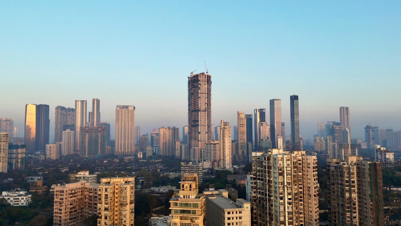 City skyline of high-rise towers under a clear sky at dawn